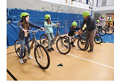 Students on bikes in a gymnasium
