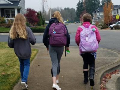 three young girls walking to school