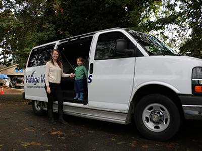 Woman taking child to daycare with Village Vans before going to work